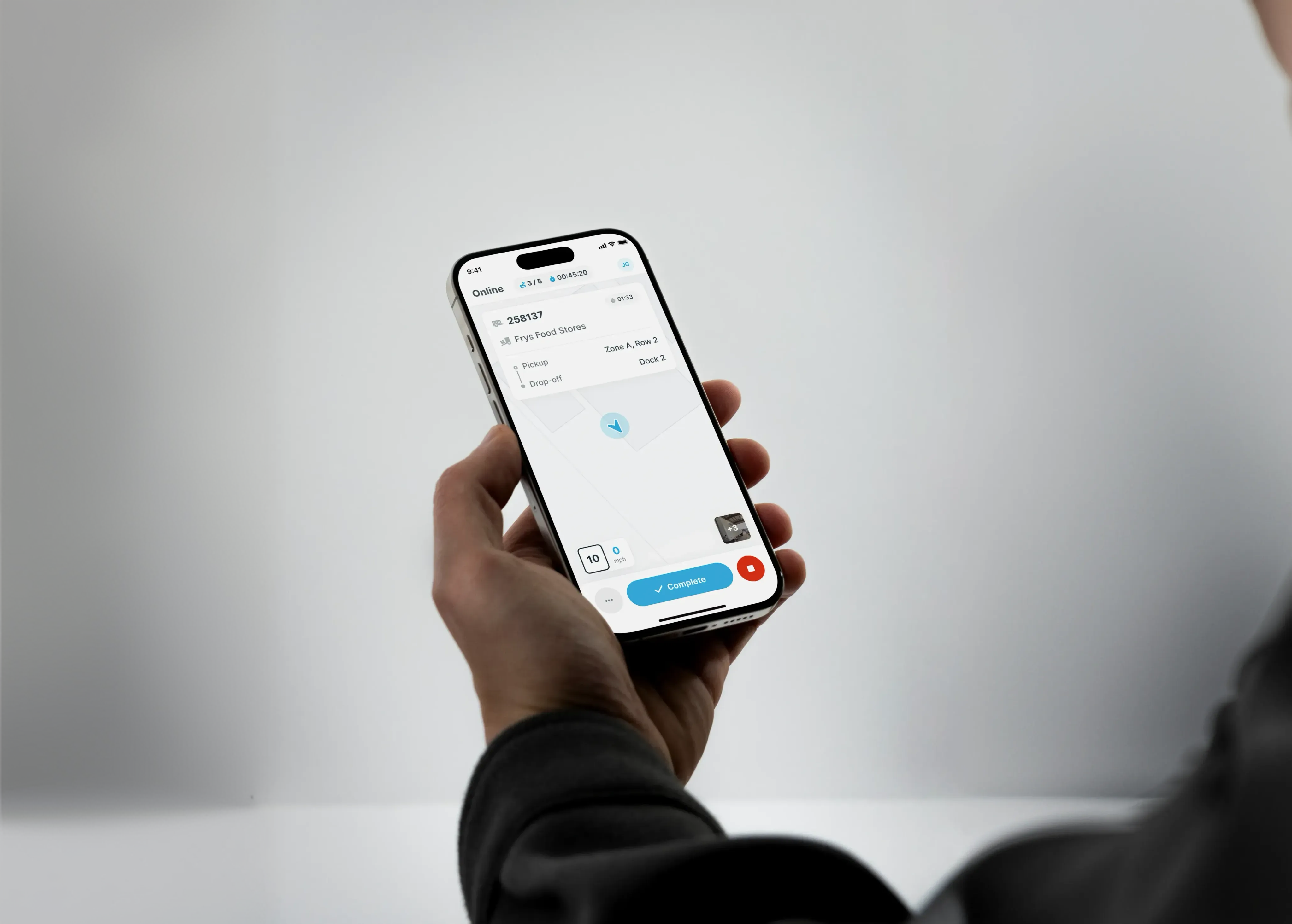 A hand holding a phone displaying the Yard Tasking driver app